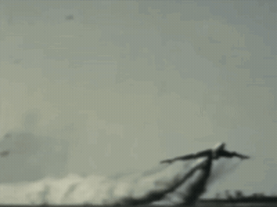 A Plane Is Flying Through The Air With Smoke Trails Behind It GIF