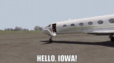 A Plane Is Sitting On A Runway With The Words Hello Iowa Written Below It GIF