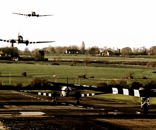 A Plane Is Taking Off From A Runway And Another Plane Is Flying In The Background GIF