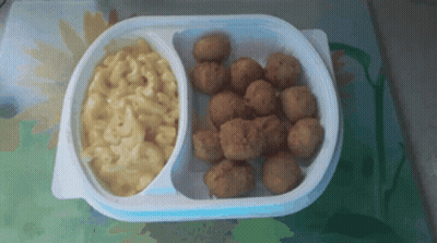 A Plastic Container Of Macaroni And Cheese And Fried Chicken Balls GIF
