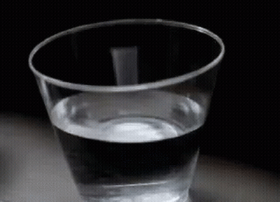 A Plastic Cup Filled With Water On A Table . GIF