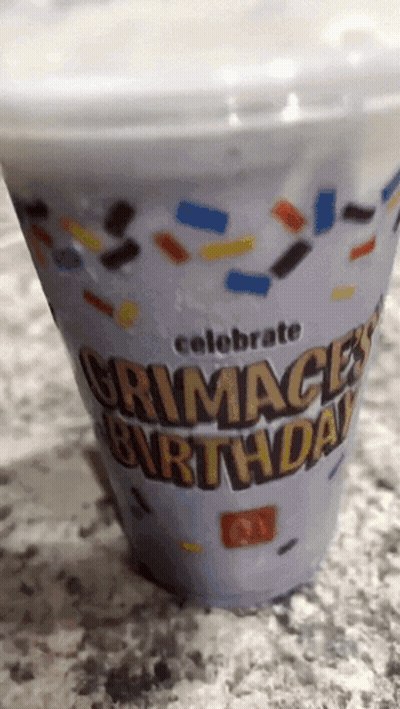 A Plastic Cup That Says Grimace 'S Birthday On It GIF