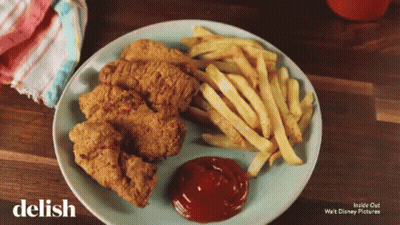 A Plate Of Chicken Nuggets And French Fries With Ketchup On It GIF