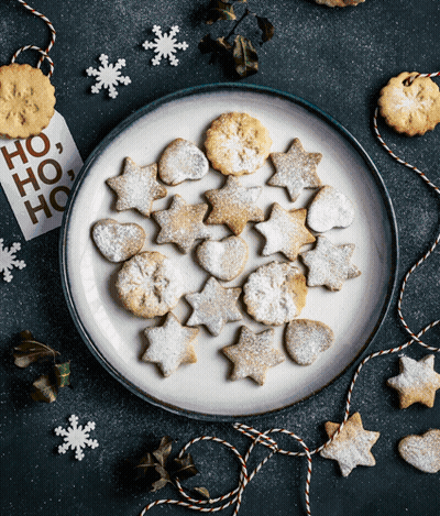 A Plate Of Cookies With A Tag That Says Ho Ho Ho On It GIF