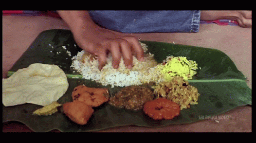 A Plate Of Food On A Banana Leaf That Says Sri Balaji Video On The Bottom GIF