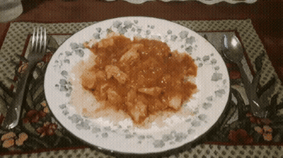 A Plate Of Food On A Placemat With A Fork And Spoon GIF