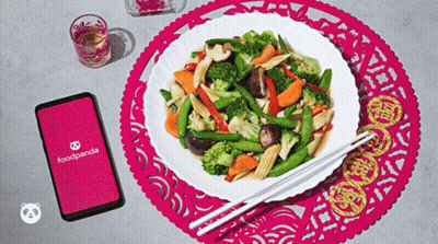 A Plate Of Food With Chopsticks Next To A Foodpanda App GIF
