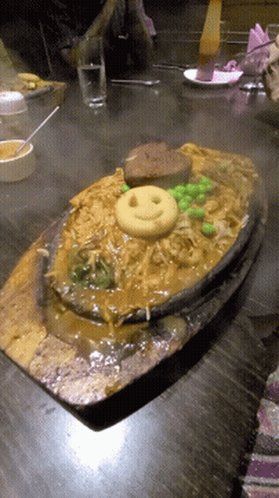 A Plate Of Noodles With A Smiley Face On Top GIF