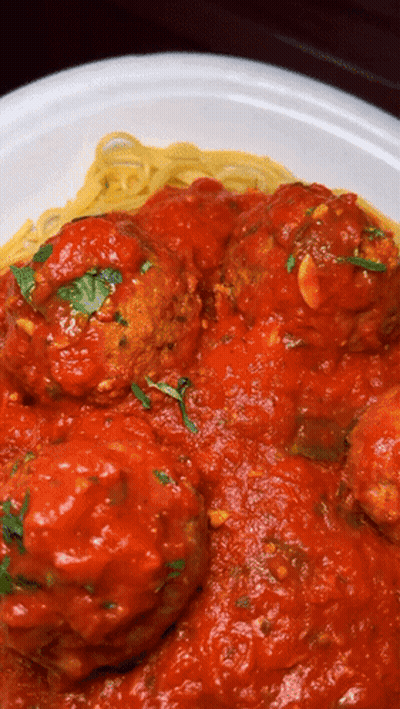 A Plate Of Spaghetti And Meatballs With Sauce On It GIF