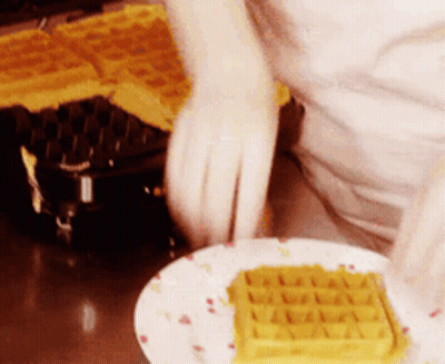 A Plate With A Waffle On It And A Person Behind It GIF
