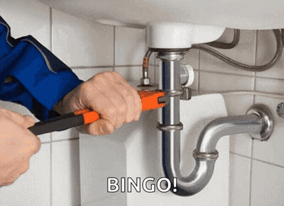 A Plumber Is Fixing A Sink Pipe With A Wrench And The Words Bingo Behind Him . GIF