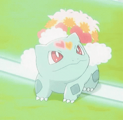 A Pokemon With A Flower On Its Head Is Sitting On A Grassy Field With Its Mouth Open . GIF