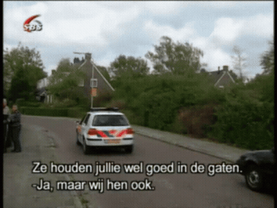 A Police Car Is Driving Down A Street With The Words Ze Houden Julie Wel Goed In De Gaten GIF