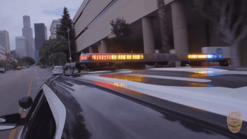 A Police Car With A Light On The Roof That Says Emergency GIF