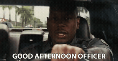 A Police Officer Is Driving A Car With The Words `` Good Afternoon Officer '' Written On The Screen . GIF