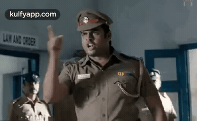 A Police Officer Is Giving A Speech In A Police Station . GIF
