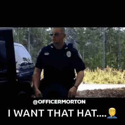 A Police Officer Is Holding A Hat In His Hand And Says I Want That Hat GIF