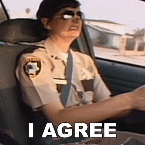A Police Officer Is Sitting In The Driver 'S Seat Of A Car With The Words I Agree Above Her GIF