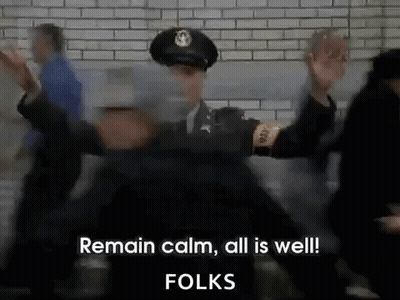 A Police Officer Is Standing In Front Of A Crowd And Says Remain Calm All Is Well Folks GIF