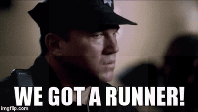 A Police Officer Is Standing In Front Of A Crowd And Says `` We Got A Runner ! '' GIF
