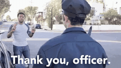 A Police Officer Is Talking To A Man Who Is Holding A Gun In His Hand . GIF
