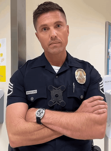 A Police Officer Named Bradford Has His Arms Crossed GIF