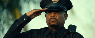 A Police Officer Salutes While Wearing A Hat That Says Police On It GIF