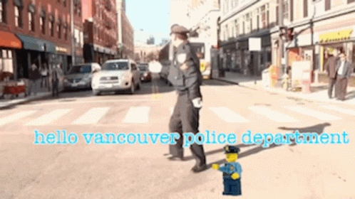 A Police Officer Walking Down A Street With The Words Hello Vancouver Police Department Written Below Him GIF