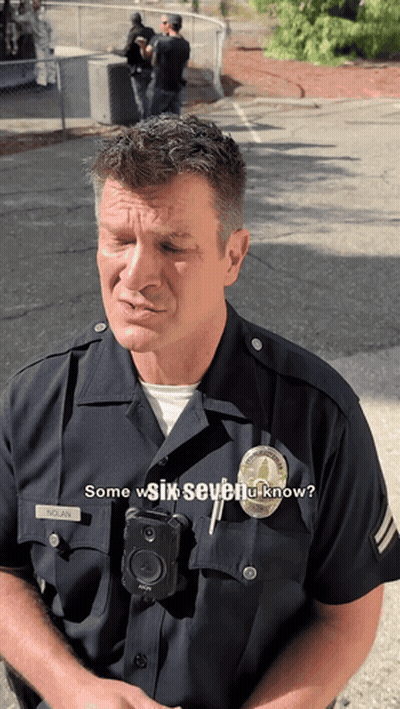 A Police Officer Wearing A Badge That Says Nolan On It GIF
