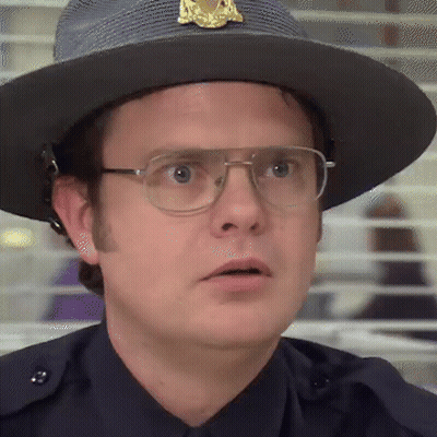 A Police Officer Wearing A Hat And Glasses Looks At The Camera GIF