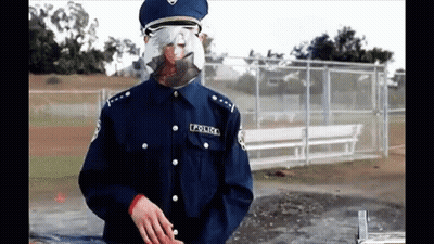 A Police Officer Wearing A Mask And Glasses GIF