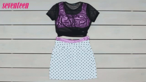 A Polka Dot Skirt And A Purple Top Are On A Wooden Table GIF