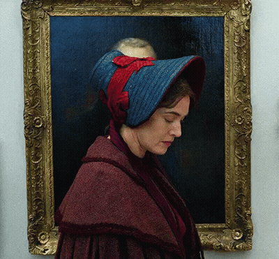 A Portrait Of A Woman Wearing A Blue Hat GIF