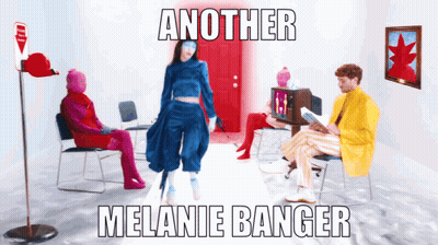A Poster For Another Melanie Banger Shows A Woman In A Blue Outfit Standing In Front Of A Red Door GIF
