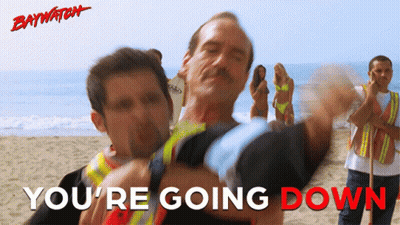 A Poster For Baywatch Shows A Man Being Lifted By Another Man GIF