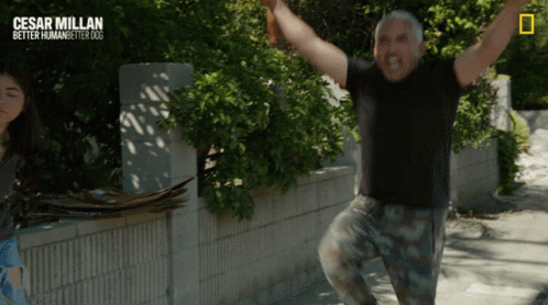 A Poster For Cesar Millan Better Human Better Dog With A Man Jumping In The Air GIF
