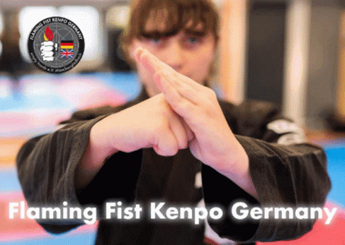 A Poster For Flaming Fist Kenpo Germany Shows A Person Holding A Black Object GIF