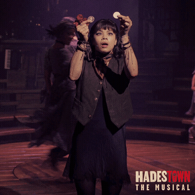 A Poster For Hadestown The Musical Shows A Girl Holding A Coin In Her Hand GIF