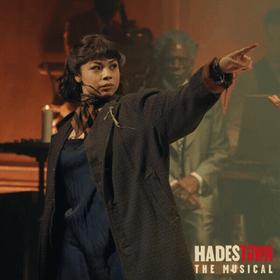 A Poster For Hadestown The Musical Shows A Woman Pointing Her Finger GIF