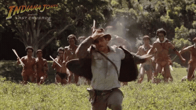 A Poster For Indiana Jones And The Last Crusade Shows A Man Running In A Field GIF