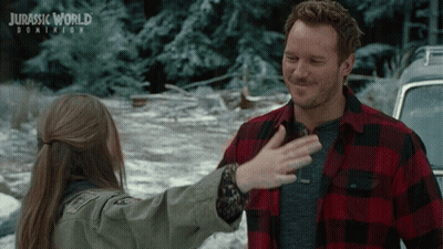 A Poster For Jurassic World Dominion Shows A Man And A Girl Hugging GIF