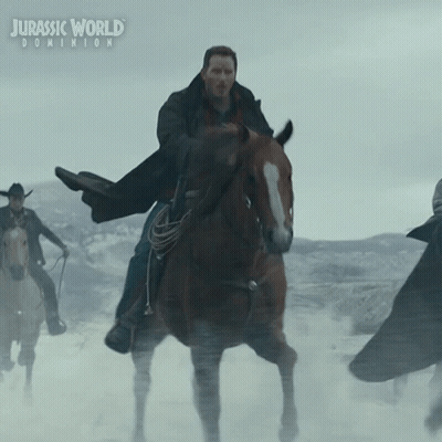 A Poster For Jurassic World Dominion Shows A Man Riding A Brown Horse GIF