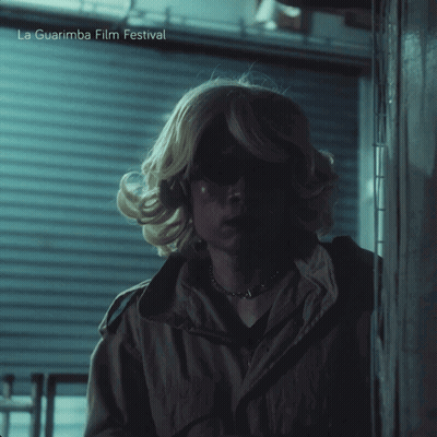 A Poster For La Guarimba Film Festival Shows A Woman In A Blonde Wig GIF