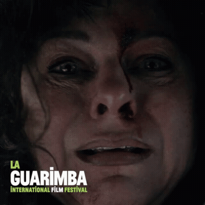 A Poster For La Guarimba International Film Festival Features A Woman With Blood On Her Face GIF