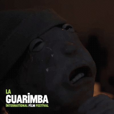 A Poster For La Guarimba International Film Festival With A Person 'S Face On It GIF
