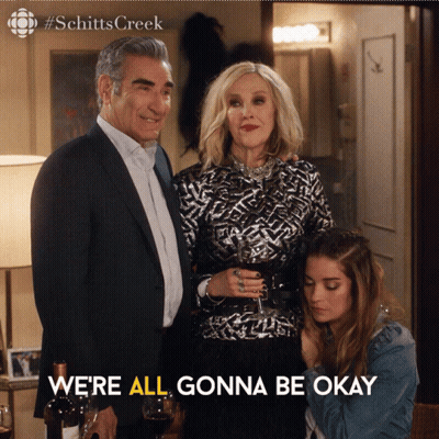 A Poster For Schitts Creek Shows A Man And Woman Standing Next To Each Other GIF