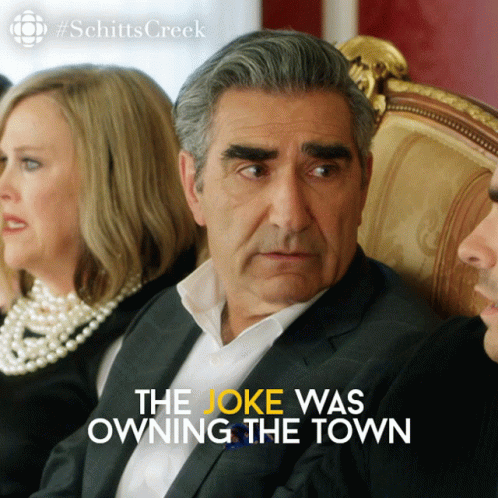 A Poster For Schitts Creek Shows A Man Sitting In A Chair GIF