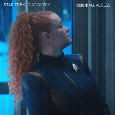 A Poster For Star Trek Discovery Shows A Woman With Red Hair Making A Funny Face GIF