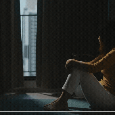 A Poster For Systemic Altruism Shows A Woman Sitting On The Floor GIF