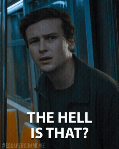 A Poster For The Escape Room Movie Shows A Man And The Words The Hell Is That GIF